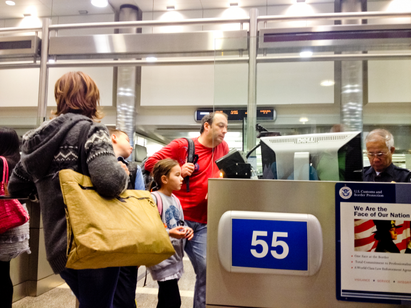 U.S. Immigration officer checking documents of tourists