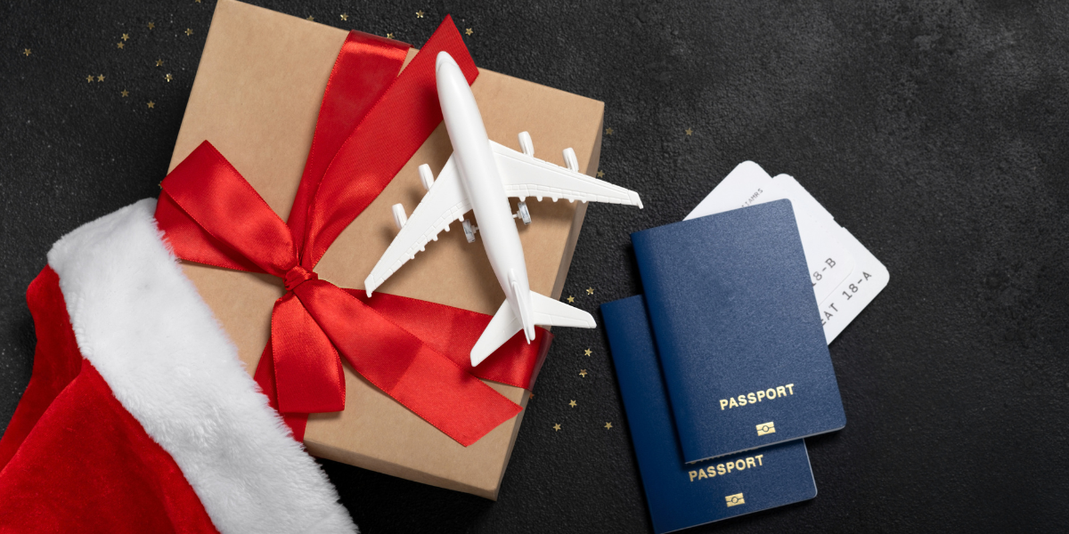 Passport, plane tickets, and holiday gift representing international holiday travel