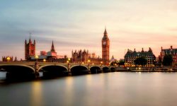 Scenic view of Big Ben and Westminster Bridge over the Thames River at sunset in London, UK.